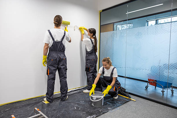 Wall painting. Group of housekeeping staff painting the walls in the office